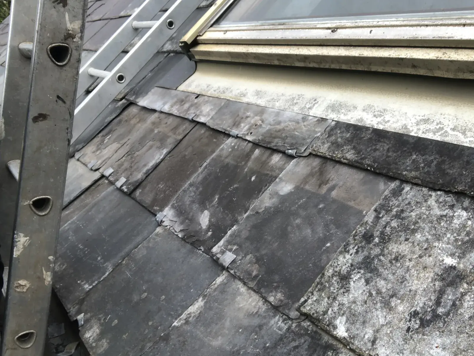 Completed reclaimed Welsh slate repair below a roof window