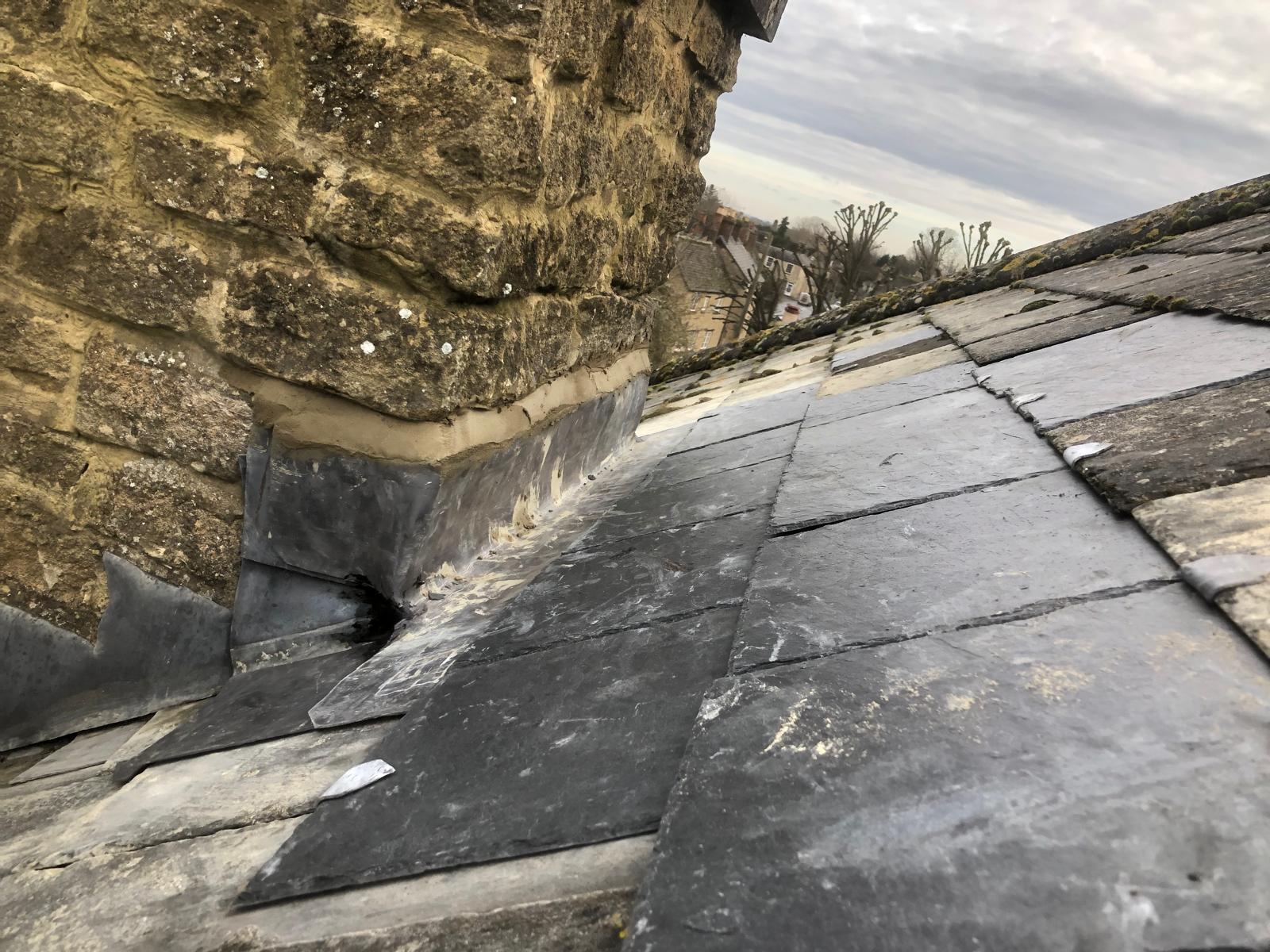 Completed chimney flashing repair viewed from the opposite roof slope