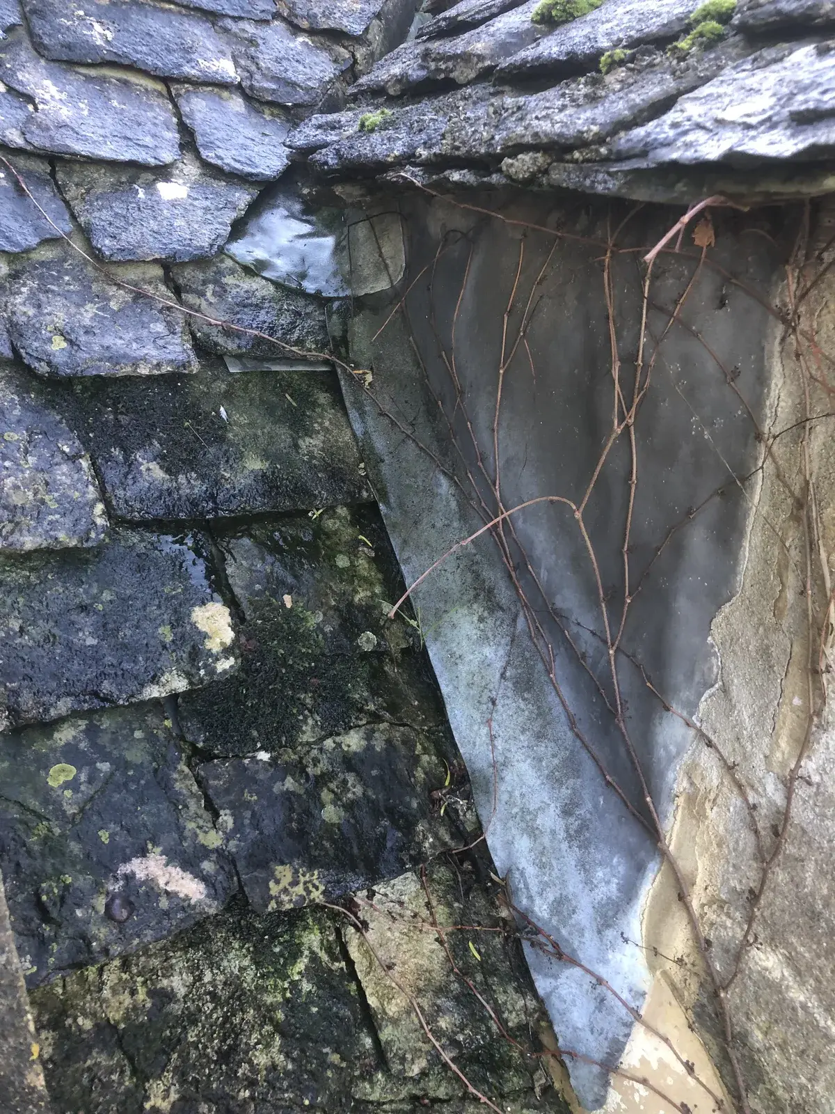 Dormer cheek and slate roof junction before the leadwork repair