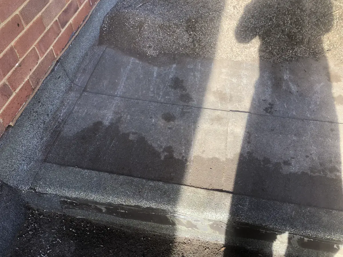 Exposed felt joints on a flat roof after the surface stone was cleared