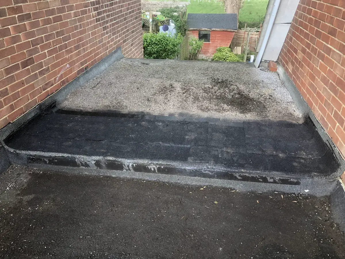 New torch-on felt sealing the vulnerable jointed section of a flat roof