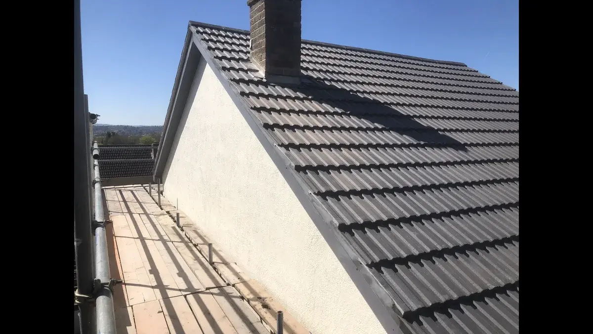 Completed black tiled roof viewed along the gable wall