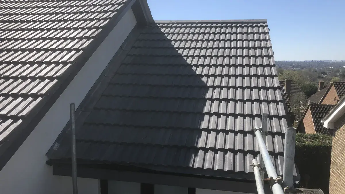 Completed interlocking tiles across the rear roof slopes and adjoining roofline