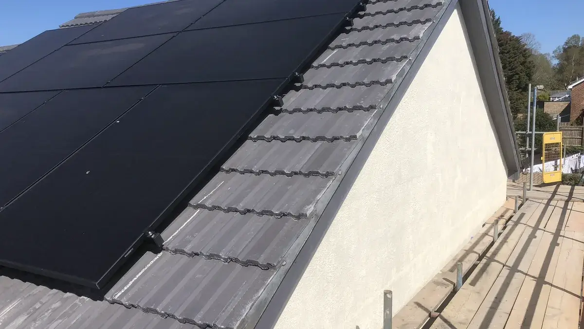 Completed tiled roof and gable beside the existing solar panel array