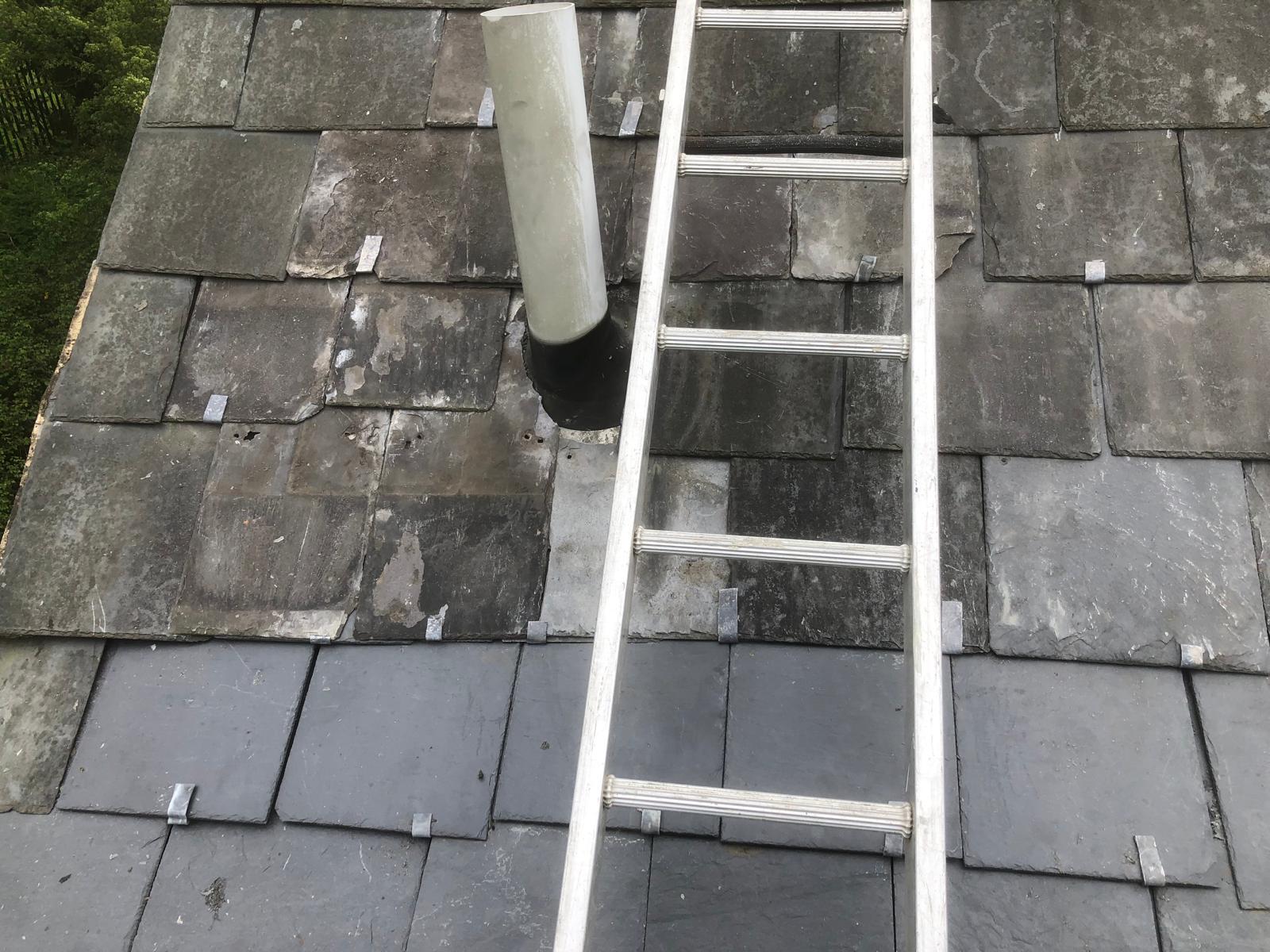 Completed slate repair around a boiler flue