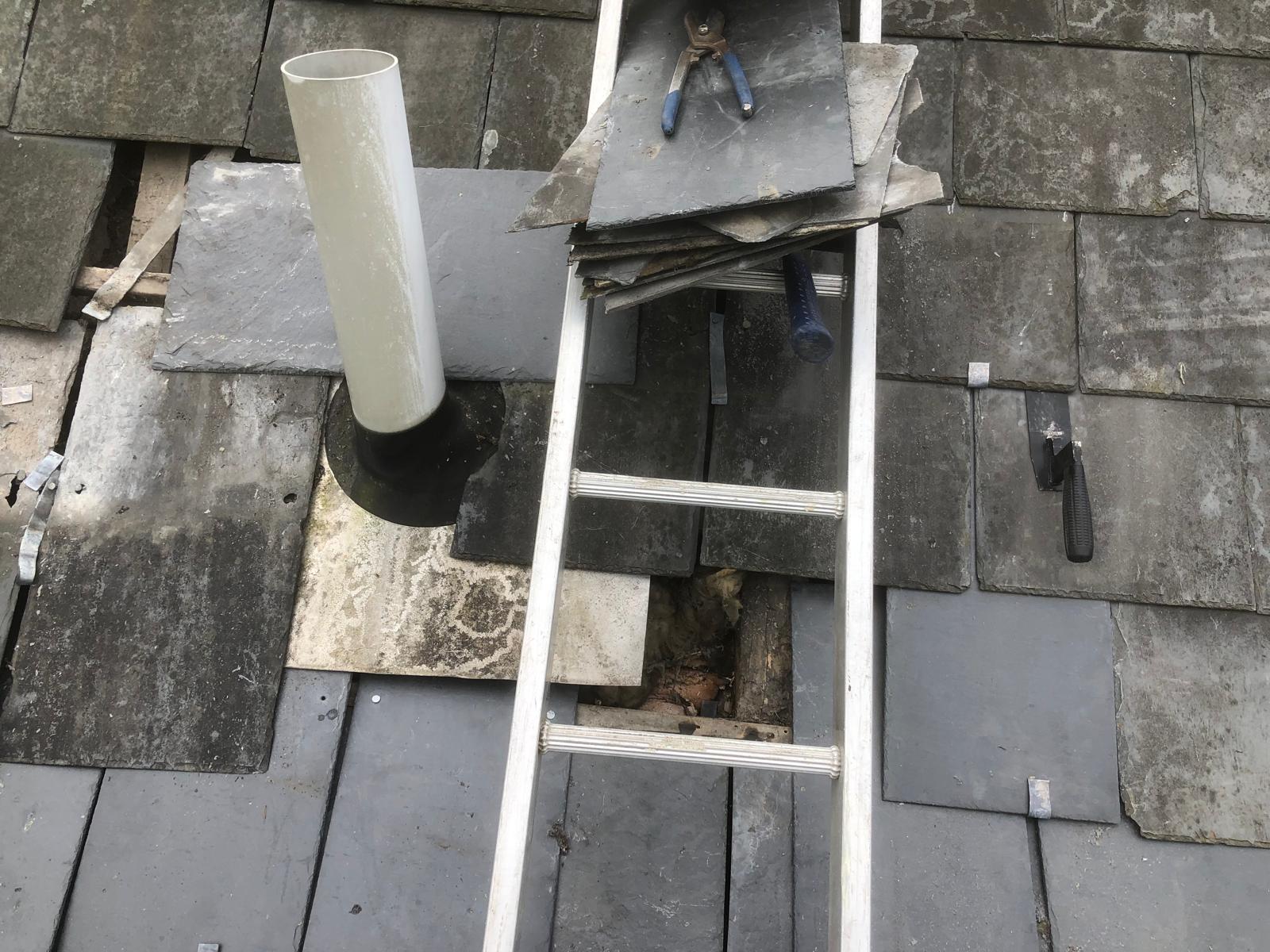 Available reclaimed slates being sorted beside the exposed flue area