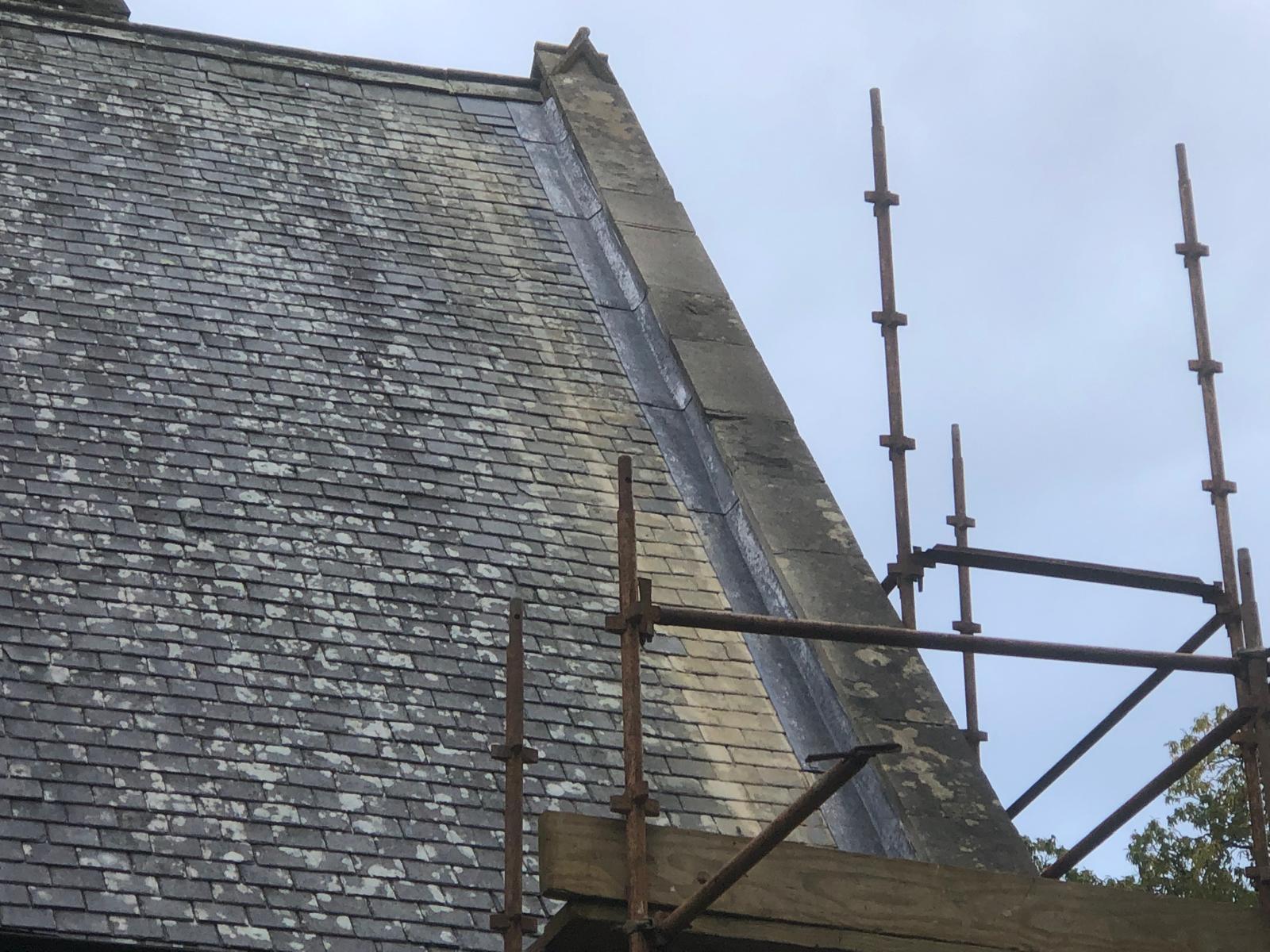 Completed Welsh slate and leadwork repair at a stone gable