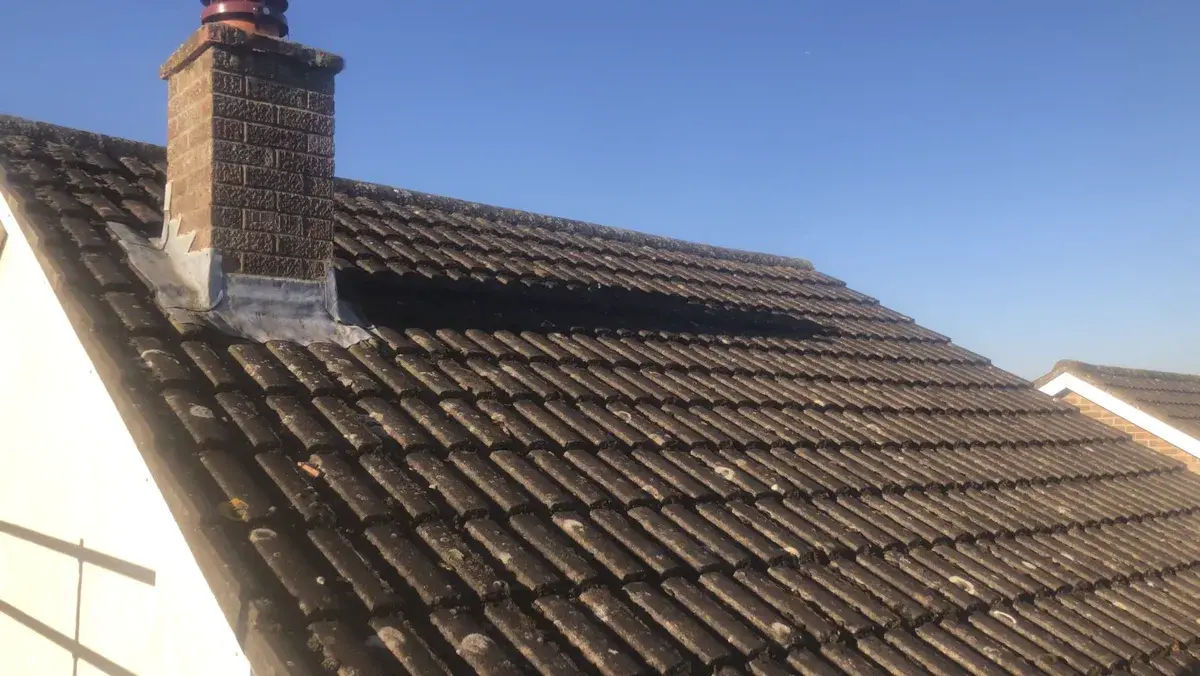 Weathered interlocking tiled roof before a planned full renewal